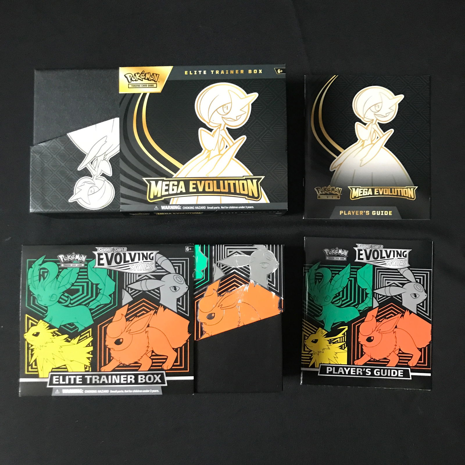 LOT OF MEGA EVOLUTION BOX AND PLAYERS GUIDE AND EVOLVING SKIES BOX AND PLAYERS GUIDE: Prices are in Canadian dollars