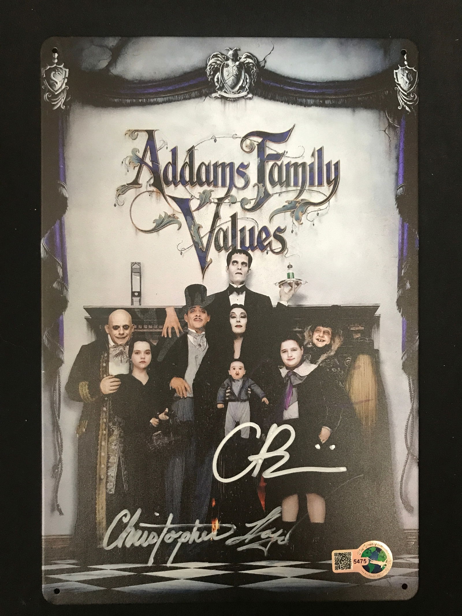 CHRISTINA RICCI AND CHRISTOPHER LLOYD DUAL SIGNED ADDAMS FAMILY TIN SIGN - WWOC COA: Prices are in Canadian dollars