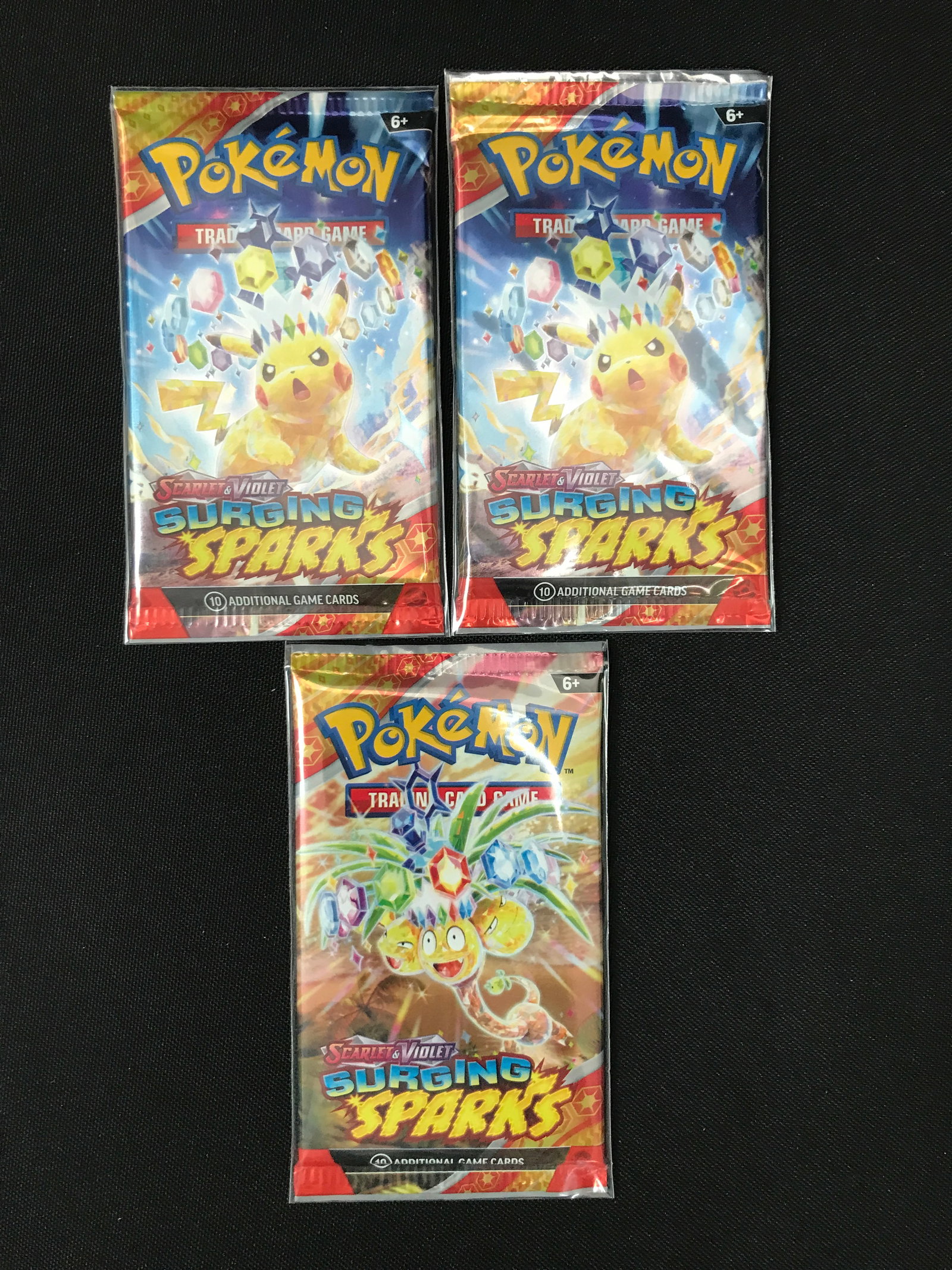 LOT OF 3 POKEMON TCG SCARLET & VIOLET SURGING SPARKS SEALED BOOSTER PACKS: Prices are in Canadian dollars