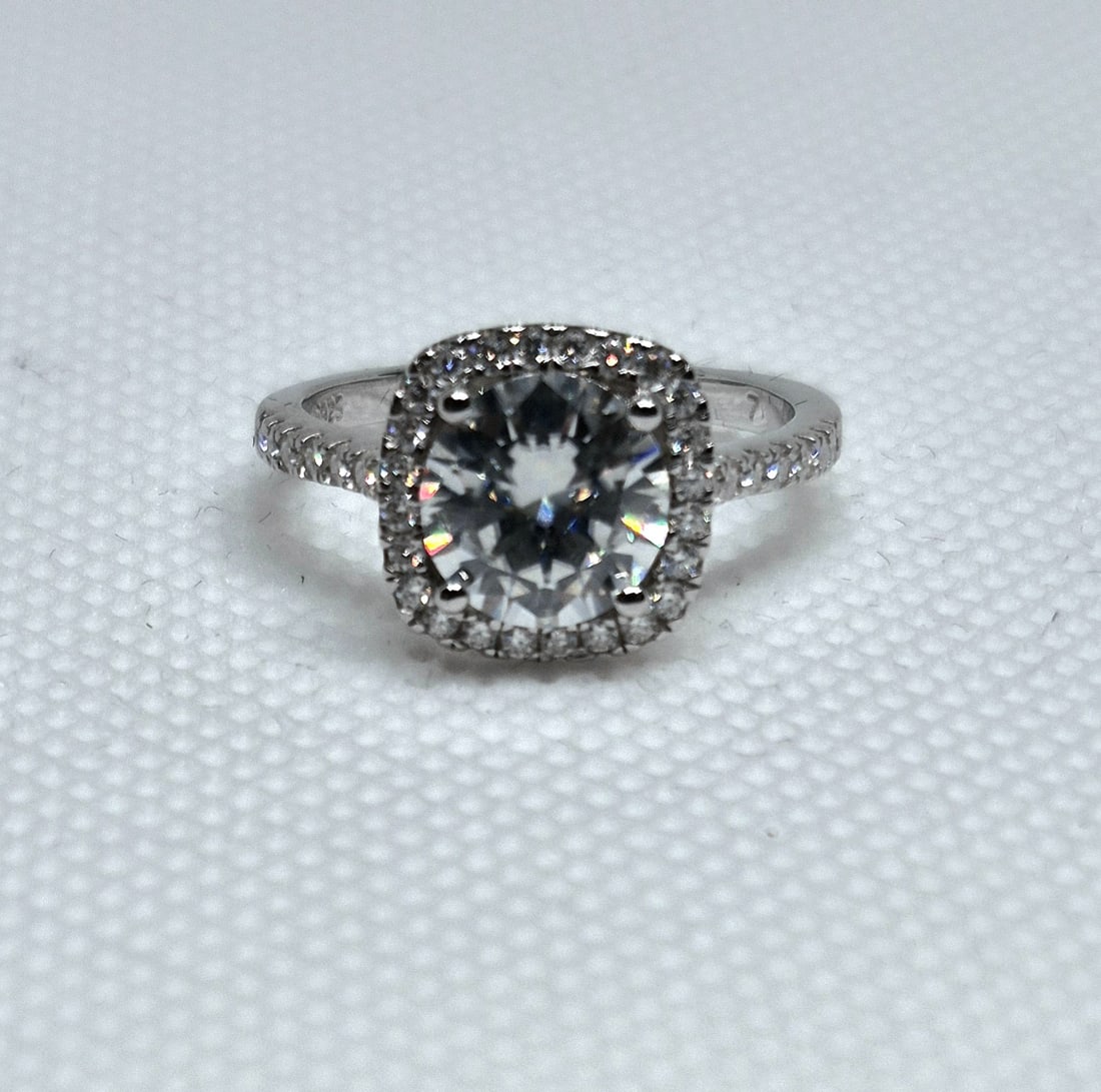 2.4 Carat Round Cut Sterling Silver Moissanite Halo Ring WITH GRA REPORT: 2.4 Carat Round Cut Sterling Silver Moissanite Halo RingCenter stone: 2.0 ct × 1 Halo stones: 0.008 ct × 24 = 0.19 ctBand stones: 0.015 ct × 14 = 0.21 ctAll = VVS1 / D925 Sterling SilverComes with 