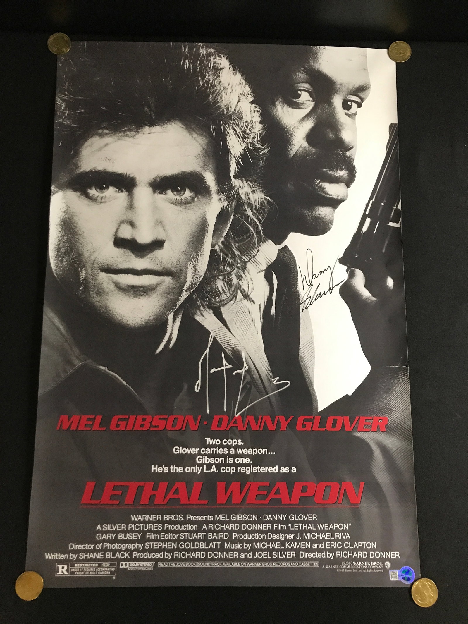MEL GIBSON AND DANNY GLOVER DUAL SIGNED LETHAL WEAPON MOVIE POSTER - WWOC COA: Prices are in Canadian dollars