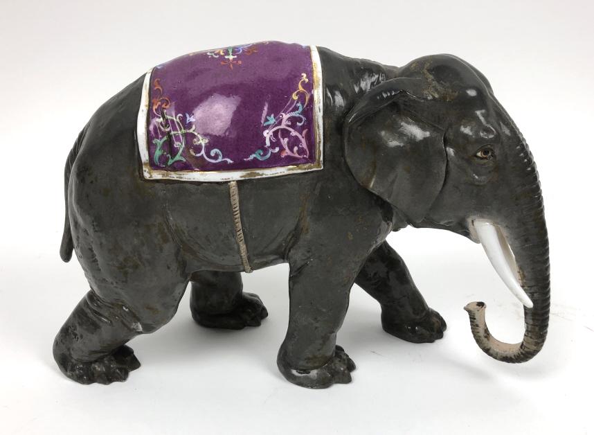 Porcelain elephant: 8 1/2"h x 12"w x 5"d Condition, old repair to one tusk, firing crack in other tusk