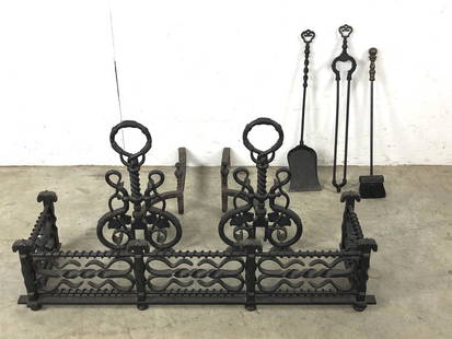 Arts & Crafts style wrought iron fire place set: Comprising andirons, fire fender and fire tools Fender 10"h x 41 3/4"w x 12"d Andirons 20"h x 11"w x 23"d Condition, light wear