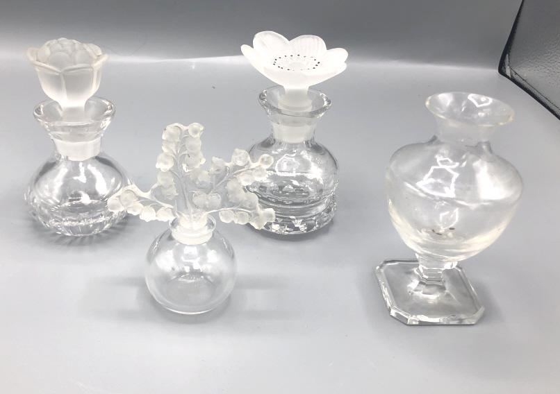 Lalique Blue bell perfume bottler: Together with two perfume bottles and vase Lalique 4 3/4"h x 3 3/4"w Condition, minor chip to Lalique stopper, other two stoppers are chipped