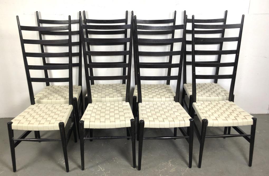 A Set of 8 Gio Ponte Style Dining Chairs: With ebonized finish and leather woven seats 50" h x 18" w x 18" d Condition, scratches scuffs , wear to finish