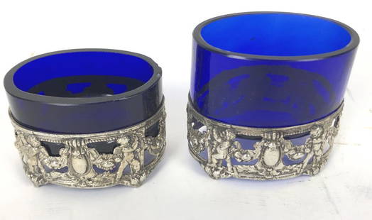 800 Silver Salt Cellars: With Bristol Glass Inserts Total weighable silver is approximately 3.75 ounces. 1 3/8" h x 3" w x 2 1/4" d. Condition, 1 leg is chipped, chips to one