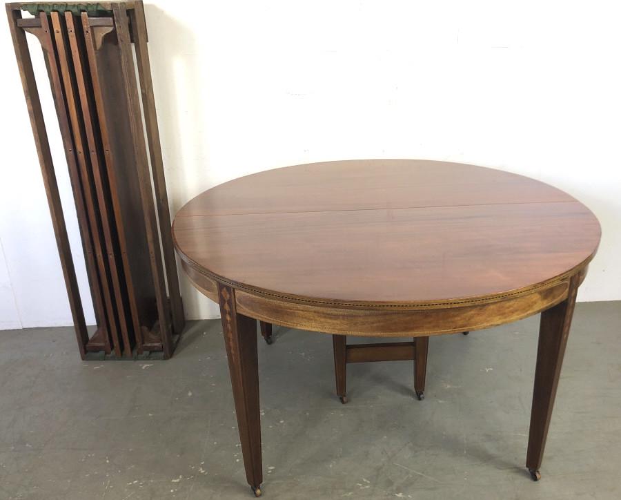Hepplewhite Style Mahogany Dining Table With inlaid: Hepplewhite Style Mahogany Dining Table With inlaid apron and legs. Including 4 10" leaves. 30 3/4" h x 54" d. Condition, some scratches and scuffs, some discoloration to finish