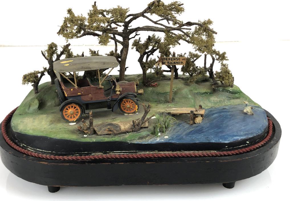 Music Box Automaton with Car Beside Pond 9"h x 15"w x: 9"h x 15"w x 7 1/2"d. Condition, overall wear, some missing pieces, automaton not working
