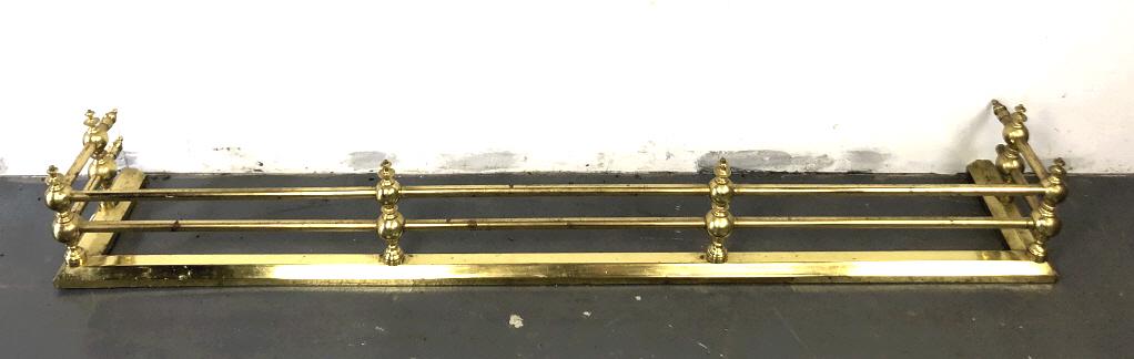 A Brass Fire Fender 9 3/4"h x 67"w x 11 1/4"d.: 9 3/4"h x 67"w x 11 1/4"d. Condition, one finial on back missing, some tarnished metal , needs polishing