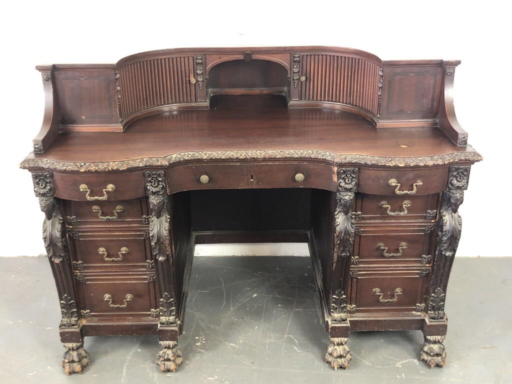 A Chippendale Revival Mahogany Demilume Desk 39 1/2"h x: 39 1/2"h x 52"w x 28 1/2"d Condition, needs cleaning, scratches and scuffs, some chipped wood, wear to feet, one divider missing in galley compartment.