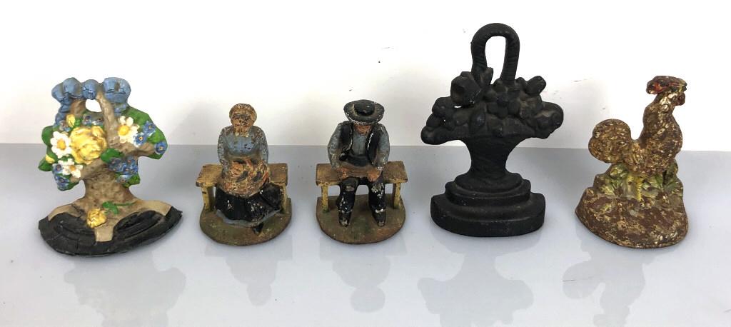 Group of Door Stops and Book Ends Approximately 5.: Approximately 5. Tallest 8 1/2" Condition, overall wear, cracked metal on floral door stop