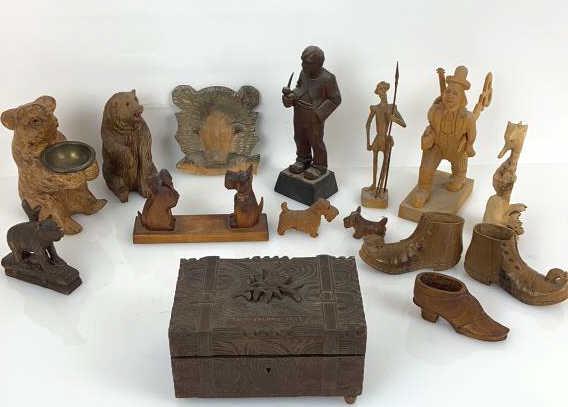 A Group of Wood Carvings and Music Box. Including: Including carvings of 3 wooden shoes, bears, men, dogs, etc. Approximately 15 items all together. Tallest carving is 8 3/4"h. Condition, scratches and scuffs, chips,
