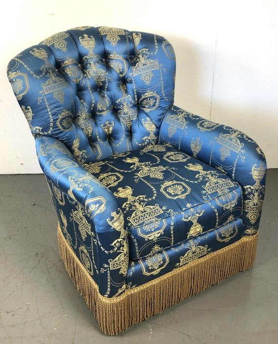 A Blue Upholstered Armchair With neoclassical: With neoclassical upholstery, with tassle skirt. 37"h x 31 1/2"w x 36"d. Condition, good