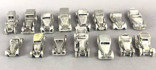 15 Danbury Mint Pewter Cars with Boxes: Including Cadillac Roadster, 1912 Packard, 1936 Jaguar, etc. Largest is approximately 5" long. Condition, some have a green discoloration, some scratches, boxes have wear