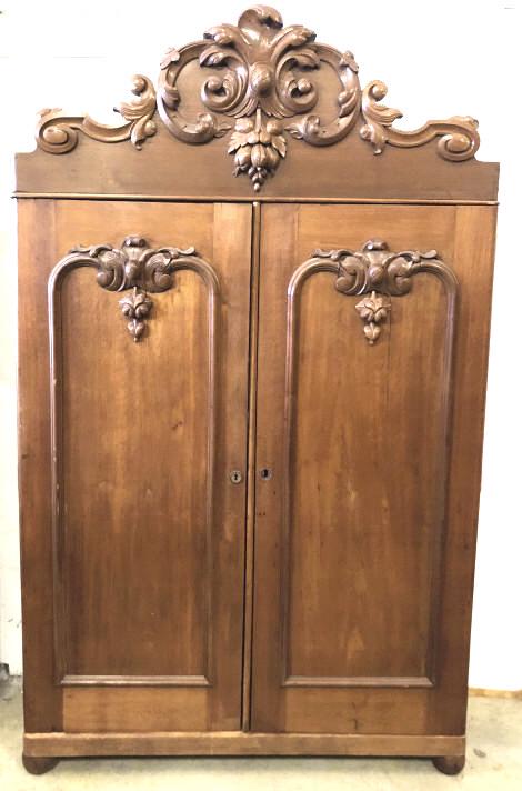 Victorian mahogany 2 door armoire: With highly carved crown and door decorations. 95"h x 57 1/2"w x 20"d Condition, missing one wood escutcheon, scratches and scuffs, some cracks
