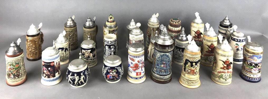 A Group of Steins: Approximately 25. Tallest is 12 1/2" Including 3 Olympic steins, 3 Anheiser Busch, Coca Cola, etc Condition, one missing lid