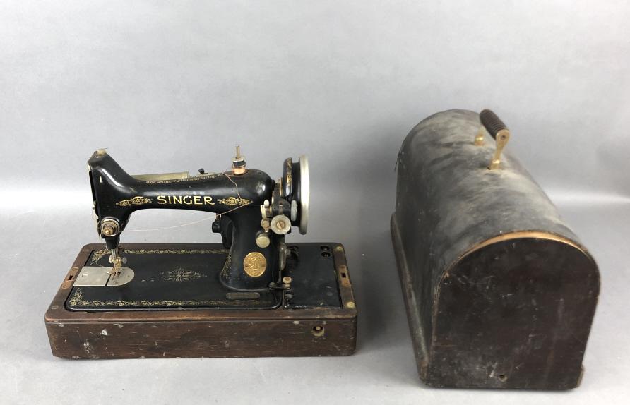 Singer Sewing Machine 12"h x 17 1/2"w x 8 1/4"d. Serial # AB271547 Condition, untested, missing: 12"h x 17 1/2"w x 8 1/4"d. Serial # AB271547 Condition, untested, missing electrical cord, overall wear, some wood de-laminating on case