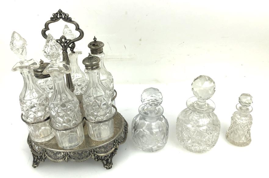 A Cruet Set Together with 3 cut crystal bottles. The cruet set is 12" tall. Condition, needs (1 of 5)