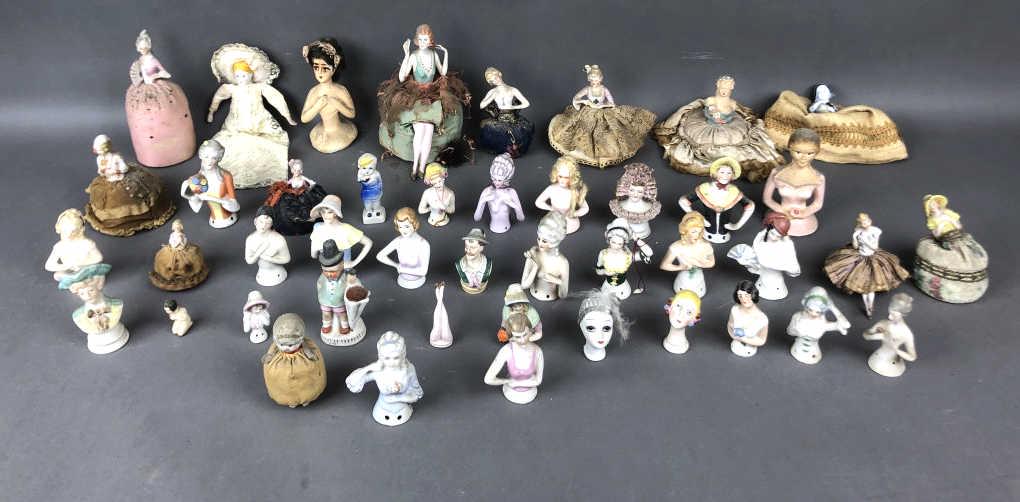 A Group of Porcelain & Other Pin Cushion Heads: Approximately 44 pieces Tallest is 7 1/2" Condition, old repairs, needs cleaning, some chips, wear to fabric