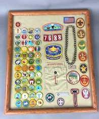 Framed Boy Scout Shirt with Badges: Approx. 65 Patches Overall size 23.25" x 19.25" Condition, some pulled threads to shirt and a couple of patches, some peeling to frame.