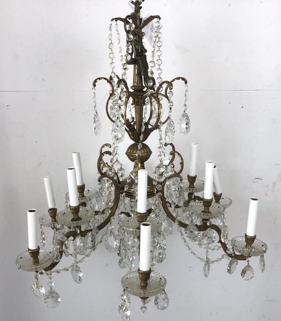 A Brass & Crystal 12 Light Chandelier: 28"h x 28" diam. Condition, re-wired, untested, some loose and missing crystals