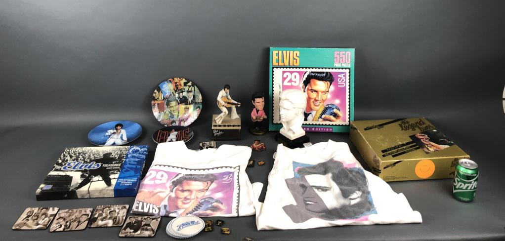 A Group of Elvis Memoribilla: Including plates, porcelain bust, bobbleheads, coasters, t-shirts, games, etc. Condition, some wear to collar of one t-shirt