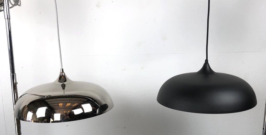 A Chrome Metal Hanging Shade: Together with a black metal hanging shade. Chrome shade is 10"h x 18" diam. Condition, some scratch marks to black shade