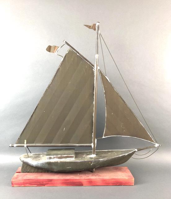 A Copper Sail Boat On A Wooden Base: 31.25"H x 30.5"W x 5.5"D. Condition, old patina to copper boat, some scratches and scuffs, needs cleaning