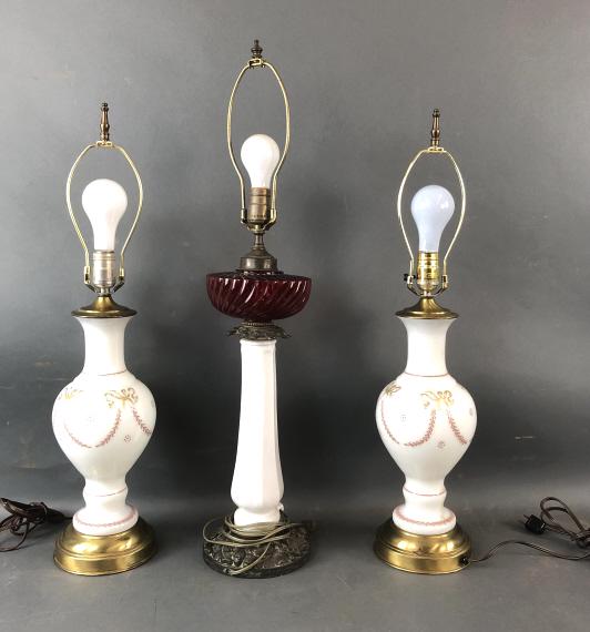 Pair of Porcelain Lamps with Cranberry Glass Lamp: Tallest measures 23" To light socket Condition, lost of gilt, wear to metal, old patina, untested,needs cleaning, crack to plastic fixture above red glass