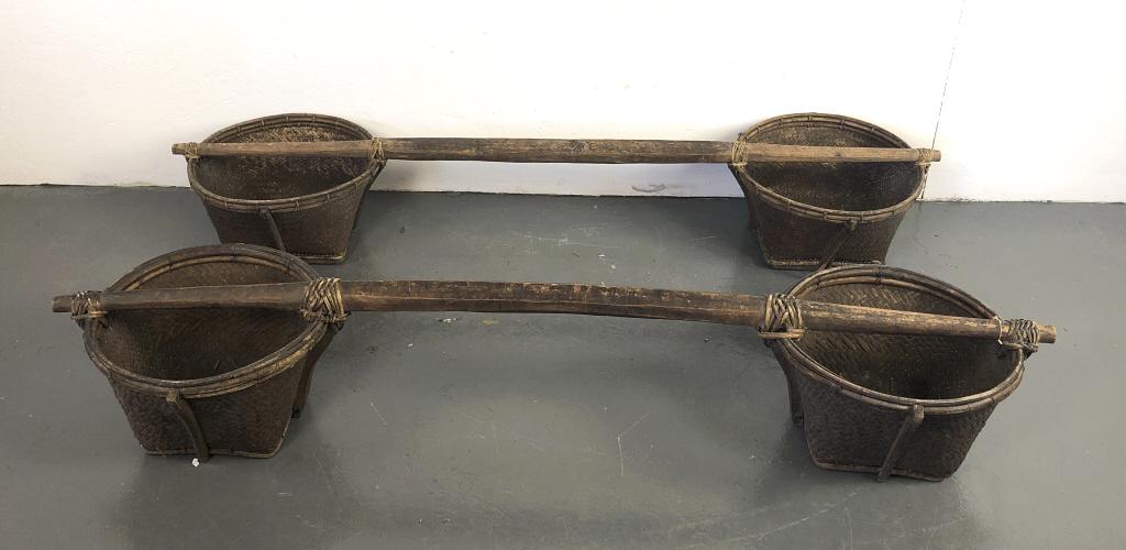 A Pair of Indonesian Basket Yokes: A Pair of Indonesian Basket Yokes. 12 1/2"h x 69"w x 18"d. Condition, some wear, one broken support