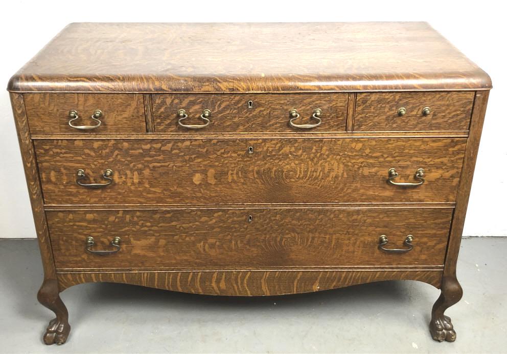 Oak Claw Foot 5 Drawer Chest: 34 3/4" h x 51" w x 23 1/2" d. Condition, some chipped veneer, one handle missing, some scratches and scuff, some paint splatter