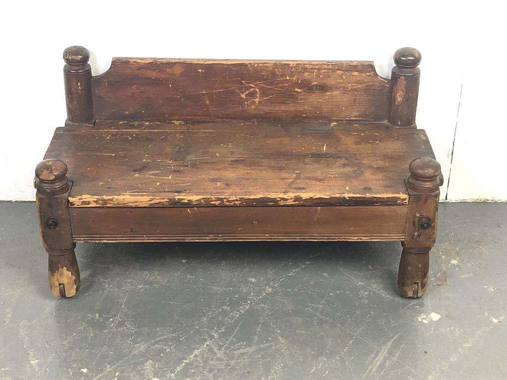 Diminutive Stained Wood Bench: Diminutive Stained Wood Bench. 17"h x 33 3/4"w x 14 1/4"d. Condition, scratches and scuffs, overall wear, one wooden wheel missing