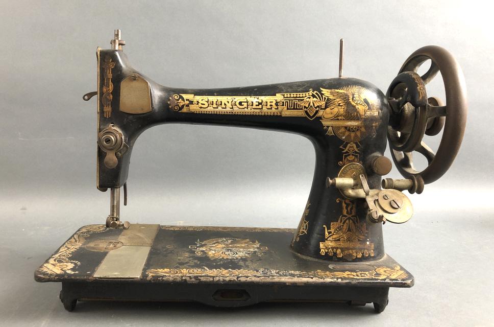Singer Sewing Machine: 11 1/2"h x 17 1/4"w x 7"d Condition, untested, scratches and scuffs, needs cleaning, wear to gold images, some surface rust