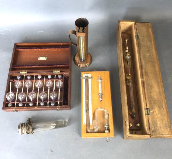 Set of Hygrometers: Set of Hygrometers. Together with thermometer, some type of flask, etc. Largest wooden box is 2 3/4"h x 18"w x 3"d. Condition - untested, one hygrometer bulb is broken, as is, overall wear