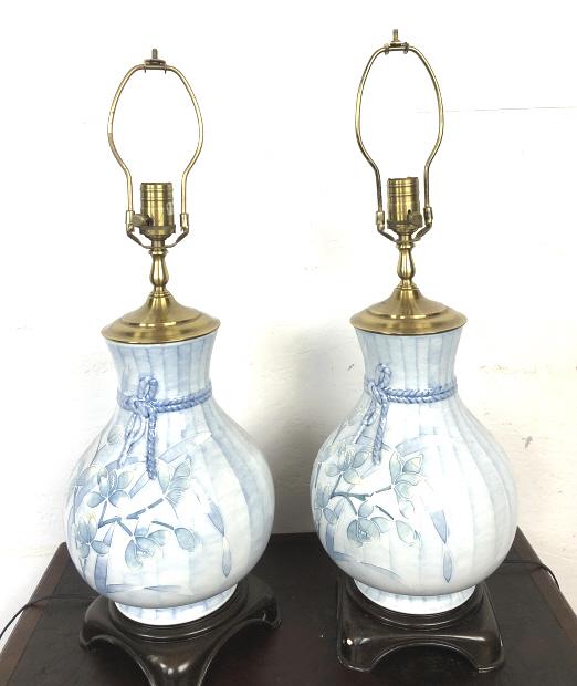 Pair or Floral Decorated Porcelain Lamps: Pair or Floral Decorated Porcelain Lamps. To top of light socket is 20" h x 9 1/2" diam. Condition, one is cracked, wear to metal, untested, scratches, scuffs and chips to bases