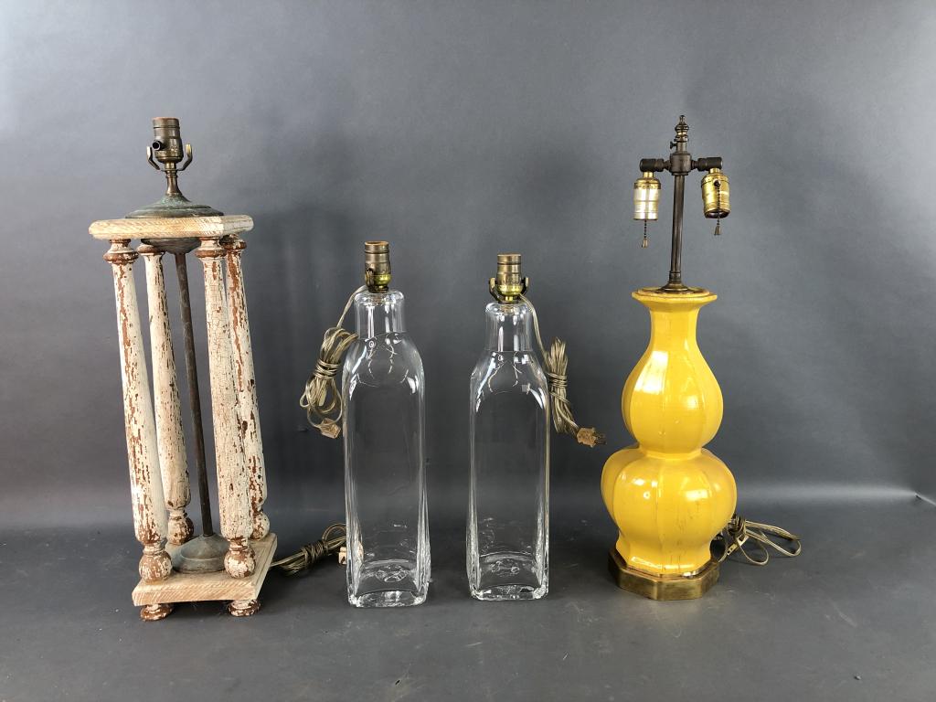 Pair of Simon Pierce Lamps: Together with a 4 column wooden lamp and a yellow painted wood lamp. The tallest Simon pierce lamp is 19 1/2" to top of light socket. Condition, peeling paint on wood lamps, old patina and wear to met