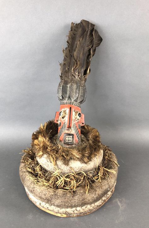 African Art - Wood Carving Headdress: African Art - Wood Carving Headdress. 18"h x 12" diam. Condition, overall wear, scratches, scuffs, loss of paint, loose feathers