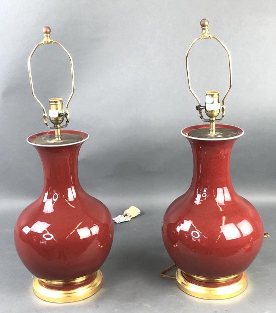 Pair of Oxblood Porcelain Lamps: Pair of Oxblood Porcelain Lamps. 19 1/2" to top of light socket x 11" diam. Condition, untested