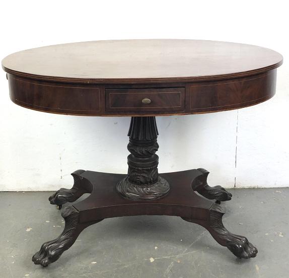 Mahogany Oval Paw Foot 4 Drawer Table: Mahogany Oval Paw Foot 4 Drawer Table. On caster wheels. 30 1/2"h x 41 3/4"w x 31"d. Condition, scratches, scuffs, chips, crack and some chipped veneer