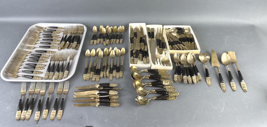 Group of Buddha Flatware from Thailand: Group of Buddha Flatware from Thailand. Approx. 150 pieces. Condition, some wear to finish, some old patina, one fork has missing prong, scratches and scuffs, some cracks on dark handles
