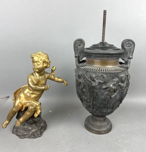 Bronze Cupid & Bronze Urn: Bronze Cupid & Bronze Urn.Bother converted to lamps, due to drilled holes.Urn is approx 14" h x 8 1/2" diam. ( not including bolt)Condition, drilled holes in cupid, scratches, scuffs, old patina