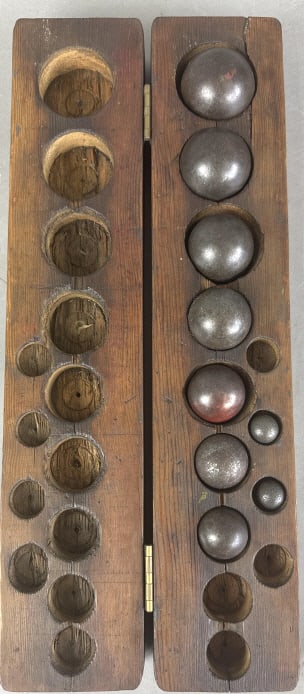 Nine Iron Balls in Wooden Box: Nine Iron Balls in Wooden Box. Largest approx. 2"d Box: 3 3/8"h x 17 3/8"w x 3 1/2"d. Condition: Scratches, scuffs, nicks, and cracks to handmade box.