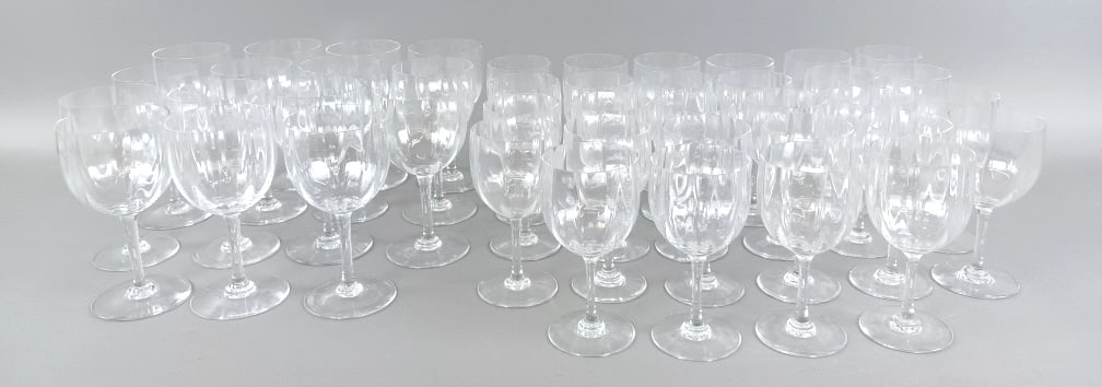 43 Baccarat Crystal Montaigne Optic Glasses: 43 Baccarat Crystal Montaigne Optic Glasses. Comprising 15 water goblets and 28 claret wines. Largest: 6 3/8"h x 3 1/4" dia. Condition: Minor wear, some with chips.