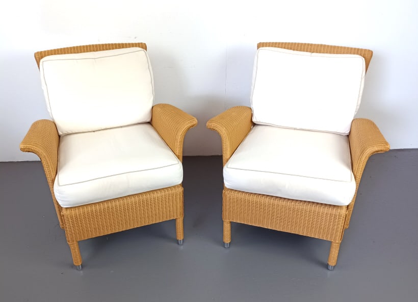 Pair of Vincent Sheppard Wicker Armchairs: Pair of Vincent Sheppard Wicker Armchairs. 34 1/2"h x 32"w x 33"d. Condition: Some minor stains to fabric, some wear to edges