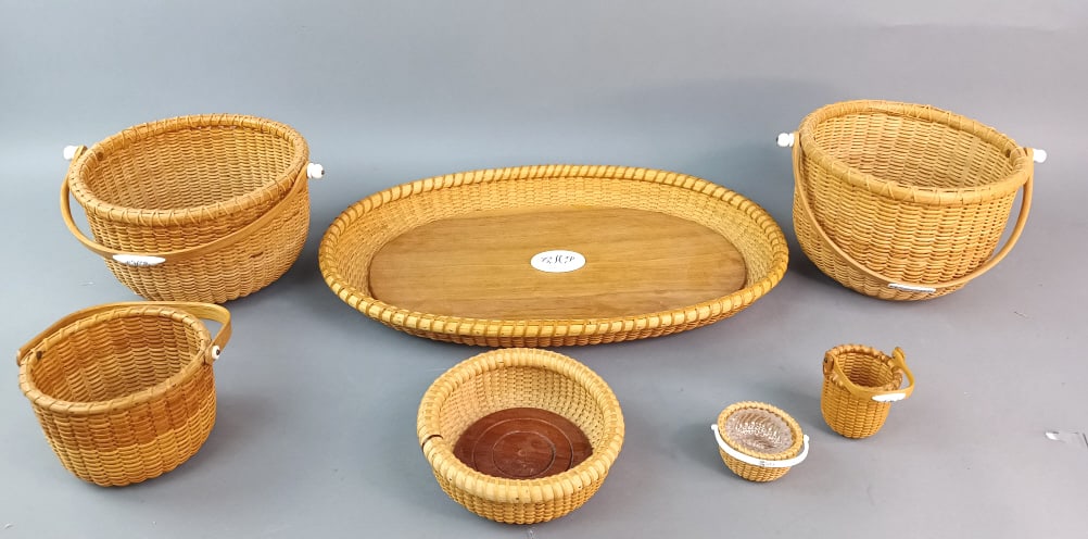 Group of Nantucket Baskets and Articles: Group of Nantucket Baskets with tray and wine coaster. Tray signed M.M. Largest: 17"w x 11 1/2"dia. 5 baskets signed. Some monogrammed and some initialed. Condition: Light wear.