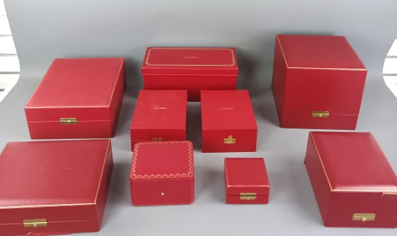 Group of Steuben and Cartier Boxes: Group of Steuben and Cartier Boxes. Nine boxes. Tallest: 8 1/2"h x 9"sq Condition: Some tears to fabric and some wear to corners. One clasp is missing on a cartier box.