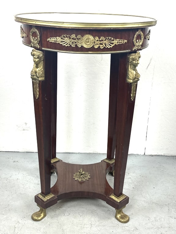 Empire Style Accent / Salon Table: Empire Style Accent / Salon Table with brass/bronze accents. 36 3/4"h x 24 1/4"diam. Condition: Some scratches, scuffs and wavy veneer.