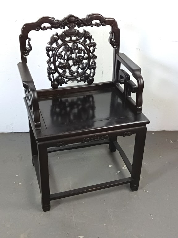 Chinese Carved Hardwood Armchair: Chinese Carved Hardwood Armchair. 39"h x 25 1/2"w x 18"d. Condition: Missing back rail to seat and some cracks to wood.