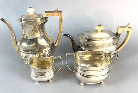 Georgian Silver 4 Piece Tea Set: Georgian Silver 4 Piece Tea Set. Approx. 46.5 OZ all in. Tallest: 9 1/2"h Condition: Handle on tea pot needs repairing. Engraved with a coat of arms, some scratches and dents.