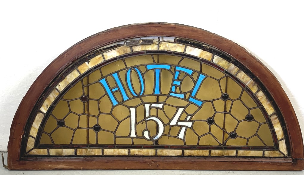 Stained Glass Transom, Hotel 154: Stained Glass Transom, Hotel 154 29"h x 58" w x 1 3/4"d Provenance: Cafe Figaro on Bleecker & MacDougal Condition: Some missing glass, some bent lead